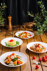 Gourmet dishes on rustic wooden table