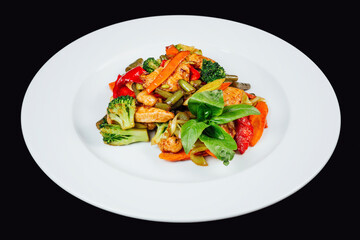 Colorful stir-fried vegetables with chicken meat on a white plate
