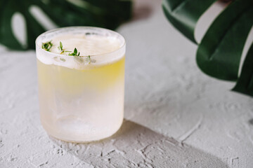 Refreshing herbal cocktail on textured surface
