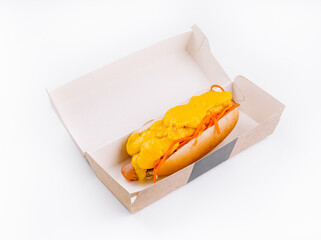 Cheesy hot dog in takeout box on white background