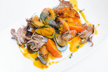 Delicious mixed seafood plate with citrus sauce