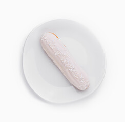 White frosted eclair on plate