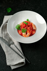 Classic homemade pasta made by hand with colored tagliatelli, ch