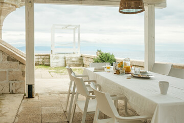Luxury breakfast on vacation, wooden table outside in the morning