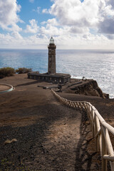 Farol da Ponta dos Capelinhos lighthouse at Faial island of the Azores, Portugal. Former beacon on the Atlantic Ocean coast. Eruption of Capelinhos volcano.