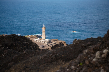 Farol da Ponta dos Capelinhos lighthouse at Faial island of the Azores, Portugal. Former beacon on the Atlantic Ocean coast. Eruption of Capelinhos volcano.