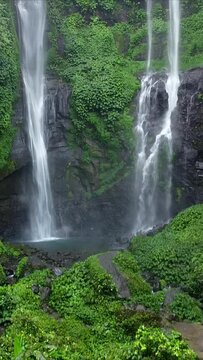 Hidden in rainforest jungle Sekumpul Waterfall one of the most highest and beautiful waterfalls on the island Bali, Indonesia. Vertical Video Clip.