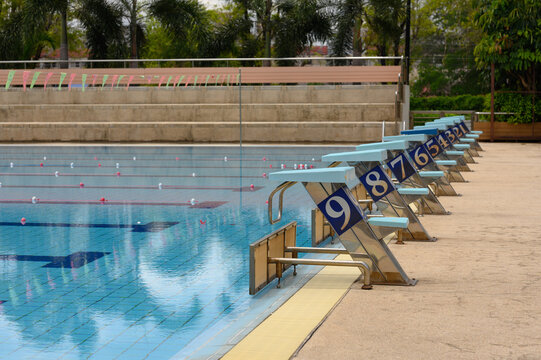 Starting blocks, jump platform in row by the swimming pool.