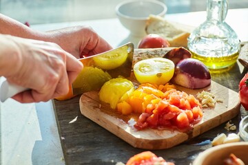 Step-by-step cooking process. Cut the yellow tomato into small pieces