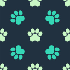 Green and beige Paw print icon isolated seamless pattern on blue background. Dog or cat paw print. Animal track. Vector