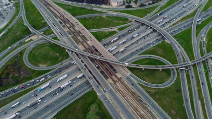 City arteries: Rush hour comes alive in aerial shot of cars streaming on urban expressways....