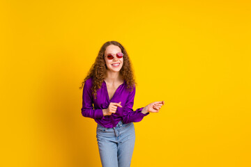 Photo portrait of lovely young lady dancing sunglass dressed stylish violet garment isolated on yellow color background