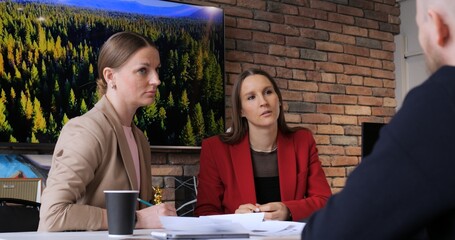 Marketing team discussing strategy in modern office. Diverse group brainstorming marketing tactics, analyzing data, planning campaigns. Women leaders, innovative ideas, collaborative environment.