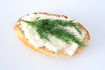 a sandwich with a green sprig of dill on top isolated on white  