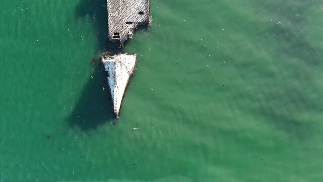 Aerial flyover view of large shipwreck