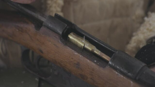 Loading bullet in vintage riffle in battle World War One