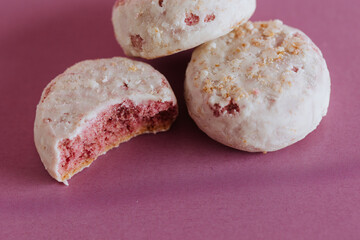 Close-up of crumbled pink cookies on a pink backdrop