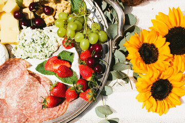 Charcuterie Board of Fresh Meats, Cheese and Fruits by Sunflowers