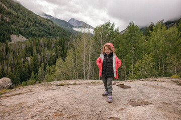 Fototapeta premium Happy child enjoying a hike in a forested mountain area