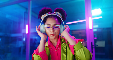 Woman, night and headphones for music, glasses and dancing for motivation in office. Happy female...