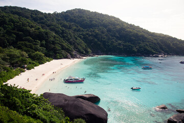 Tourists visiting a secluded sandy beach in Similan Island