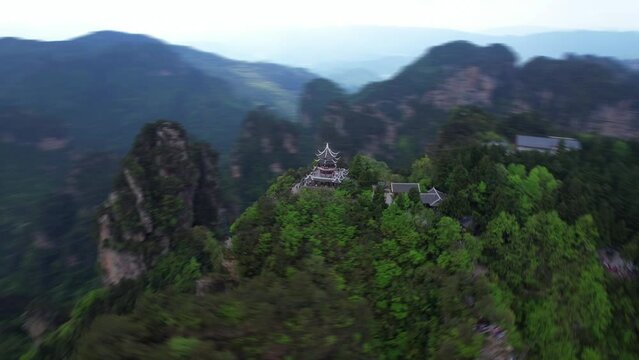 Aerial speed ramp orbit around Liuqi Pavilion in Huangshi Village. Zhangjiajie, China