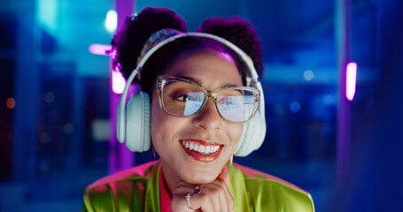 Neon, smile and woman with headphones, listening to audio and streaming music with internet....
