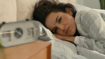 Woman sleeping lying on bed bedroom home domestic comfort early morning call alarm clock wake up...