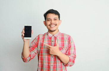 image of asian man holding phone, isolated on yellow background.