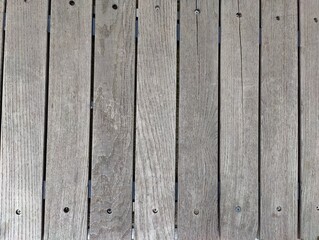 Close-Up of Weathered Wooden Surface with Natural Grain and Visible Fasteners Indicating Outdoor Use