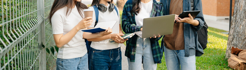 Young Asian People college students and a female student group work at the campus park in morning with her friend