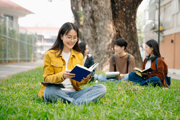 Young Asian People college students and a female student group work at the campus park in morning with her friend