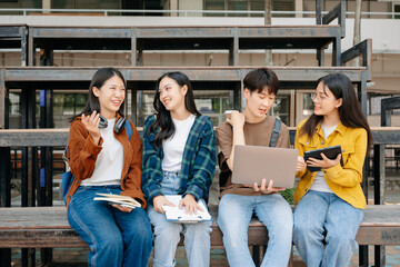 Young Asian People college students and a female student group work at the campus park in morning with her friend