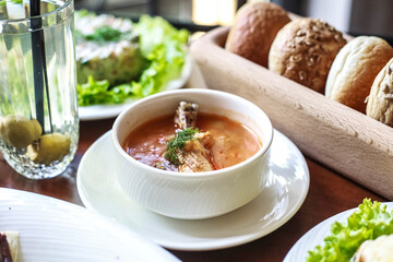 Bowl of Soup With Bread and Salad on Table