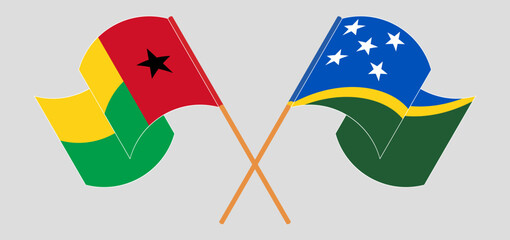 Crossed and waving flags of Guinea-Bissau and Solomon Islands