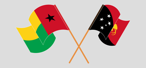 Crossed and waving flags of Guinea-Bissau and Papua New Guinea