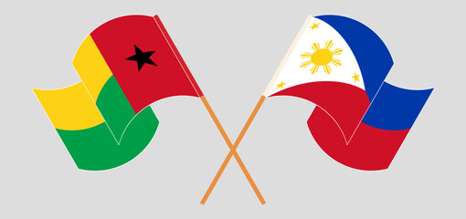 Crossed and waving flags of Guinea-Bissau and the Philippines