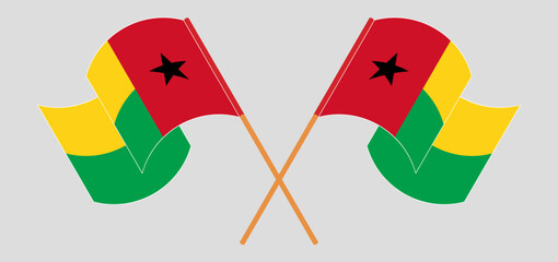 Crossed and waving flags of Guinea-Bissau