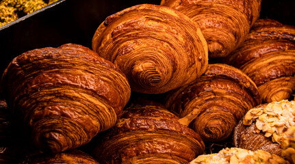 Closeup shot of a variety of freshly baked goods in a tray illuminated by warm light
