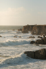 Ocean waves hitting cliffs along the coast