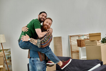 Two men embracing in a room filled with moving boxes, symbolizing a new chapter in their lives as a gay couple in love.