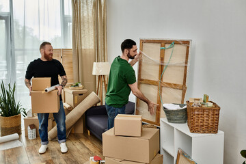Two men, a gay couple, arrange moving boxes in a living room as they begin a new chapter in their...