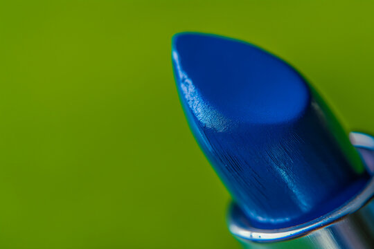 AI generated illustration of a close-up of a blue lipstick on a green background
