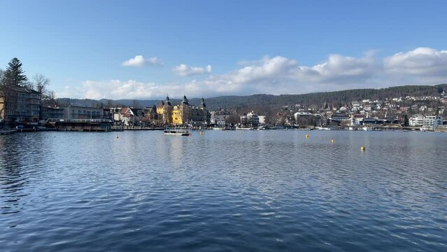 Shot of Lake Worthersee in Velden, Austria, with the Falkensteiner Hotel in the background.