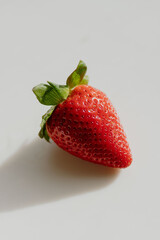 Fresh strawberry with leaf on a white table