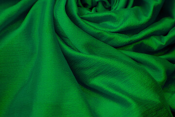 Closeup of green silk cloth fabric.