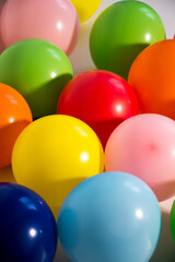 Vertical of colorful balloons grouped on white background