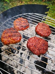 Closeup of meatballs cooking on a grill