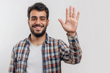 Fototapeta premium Friendly Middle Eastern Man Waving Hand in Checkered Shirt, Indoor Portrait