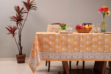 Yellow Traditional floral design table cloths on table with decoratation of plates